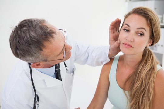 Doctor examining patients face