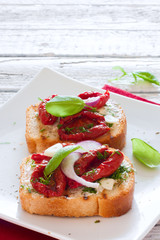 Toasts with tomatoes, basil and onions