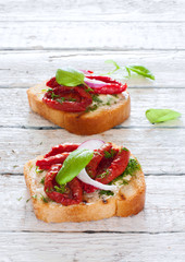 Toasts with tomatoes, basil and onions