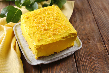 Tasty lemon cake on wooden table