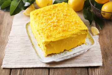 Tasty lemon cake on wooden table