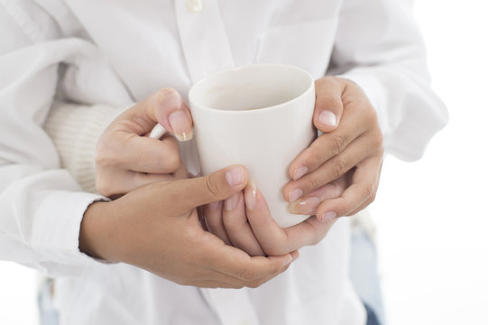 The hands of parents and children with coffee cup