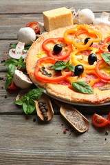 Delicious pizza served on wooden table
