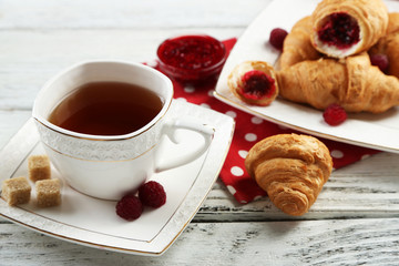 Breakfast with tea, jam and fresh croissants