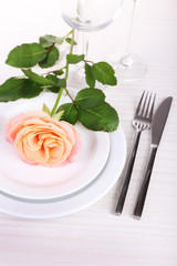 Table setting with pink rose on plate