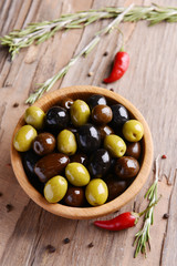 Different marinated olives on table close-up