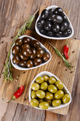 Different marinated olives on table close-up