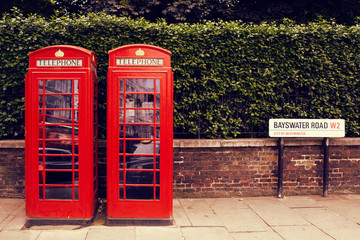 art row of traditional phone boxes in London city