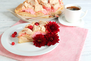 Piece of tasty pie with apples and berry mousse and cup of