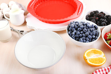 Baking tasty pie and ingredients for it on table in kitchen