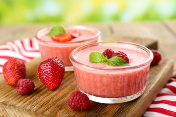 Delicious berry mousse in bowls on table close-up