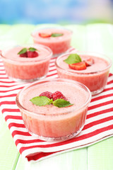 Delicious berry mousse in bowls on table close-up