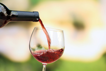 Red wine pouring into wine glass, close-up