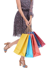 Beautiful young woman with shopping bags isolated on white