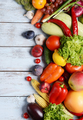 Fresh organic fruits and vegetables on wooden background