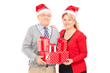 Mature couple posing with Christmas presents