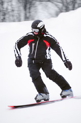Teen snowboarder in black costume