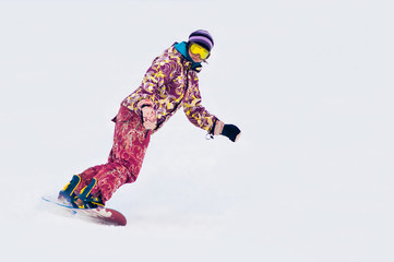 Fototapeta na wymiar Young girl snowboarder on the board