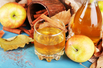 Composition of  apple cider with cinnamon sticks, fresh apples