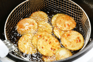 Zucchini in deep fryer, closeup