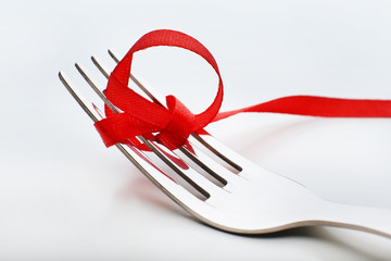 Stages of tying bow on fork, close-up