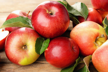 Ripe red apples on wooden background
