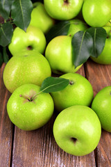 Ripe green apples on wooden background