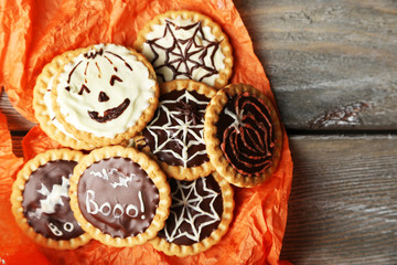 Tasty Halloween cookies on wooden table