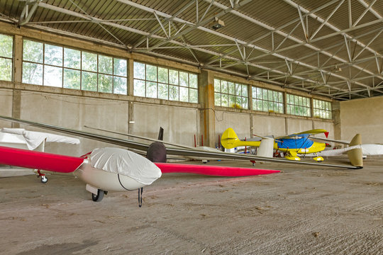Lightweight gliders stationed inside of a big hangar