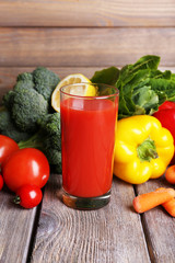Tomato juice in glass and fresh vegetables