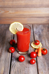 Glass of tomato juice with lemon and fresh tomatoes