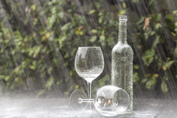 Wine Bottle and Glasses in Summer rain