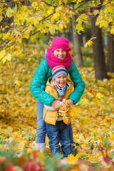 Cute kids with autumn leaves