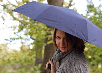 Girl with umbrella in autumn park