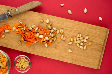 Vertical view of pumpkin flesh and seeds on cutting board