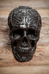 Black skull on wooden table