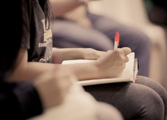 Close-up of a young girl writing into her diary