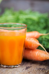 Carrot juice on wooden background