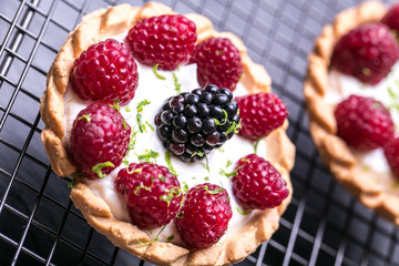 Delicious raspberry tarts on a stones board 