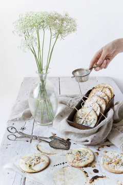 homemade cookies on white wooden table with wildflowers