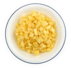 Chopped pineapple chunks in a white bowl