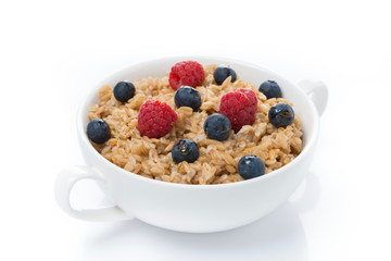 oat porridge with berries in a bowl, isolated