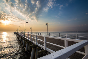 Fototapeta na wymiar Sunrise on the pier at the seaside, Gdynia Orlowo, 