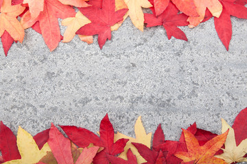 Naklejka na ściany i meble Autumn leaves on stone background