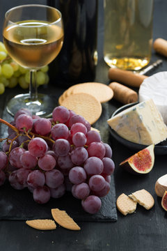 snacks - grapes, cheese and wine, close-up