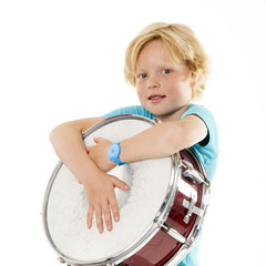 young blond boy holding drum