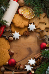 wooden background with Christmas cookies and ingredients