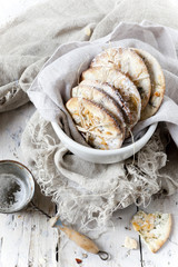 homemade cookies on bowl on white wooden table with strainer