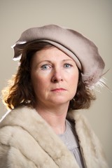 Brunette in taupe hat and fur stole