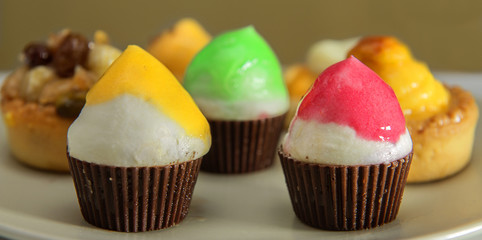 Variety of muffin type fairy cakes, cup cakes and fresh fruit ca